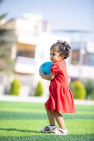 小女孩抱着足球在玩耍高清图片