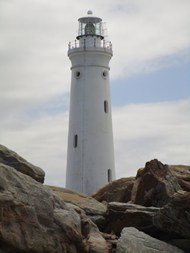 海岸岩石白色灯塔写真图片