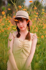 站在花海丛中戴草帽的美女图片大全