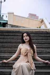 坐在台阶上的亚洲性感美女图片