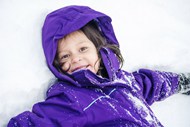 冬季躺在雪地里的可爱小女孩图片下载