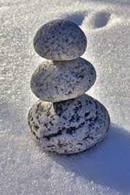 白色雪地堆叠的石块精美图片